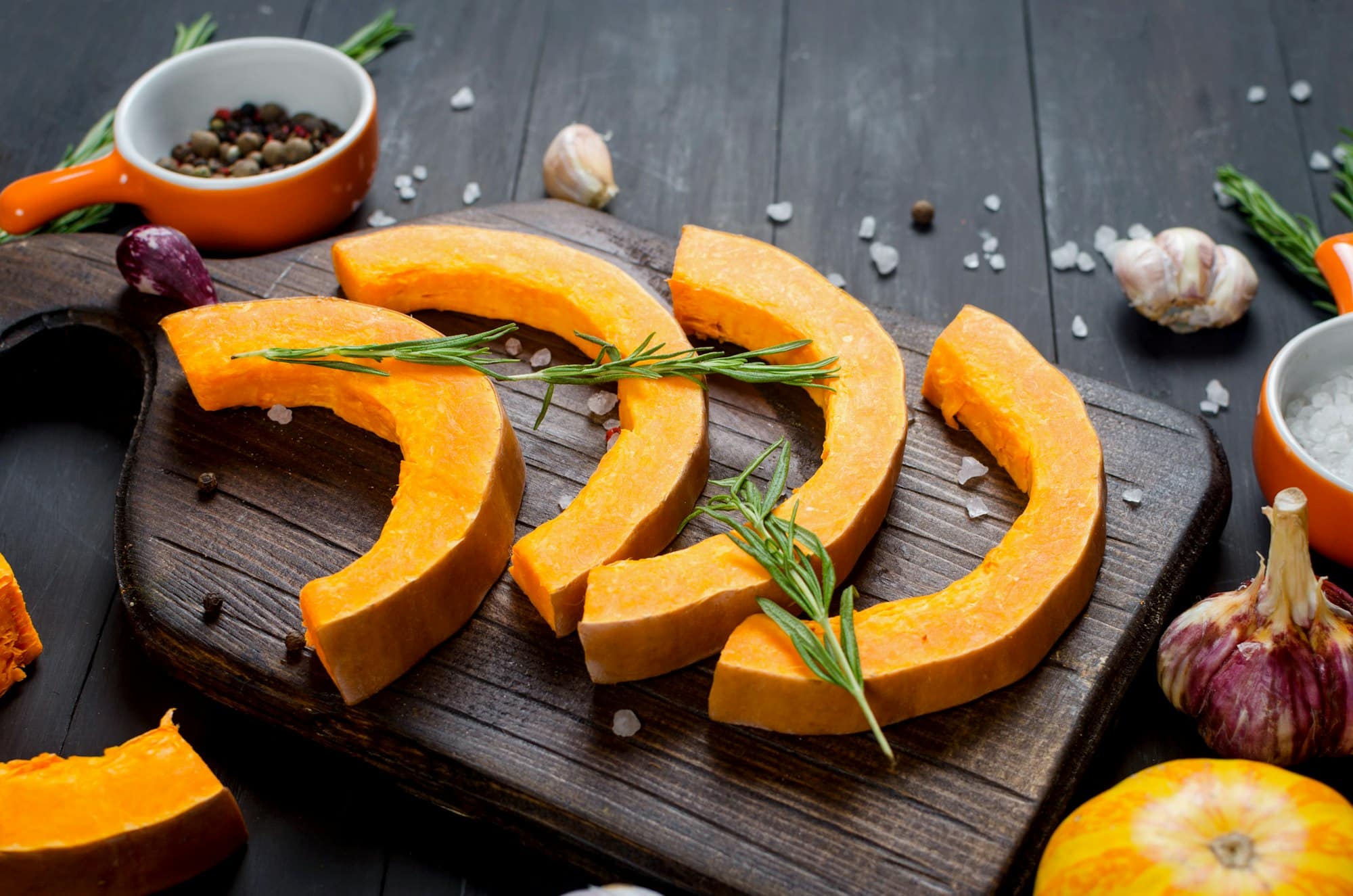 raw pieces of pumpkin prepared for baking in the oven.