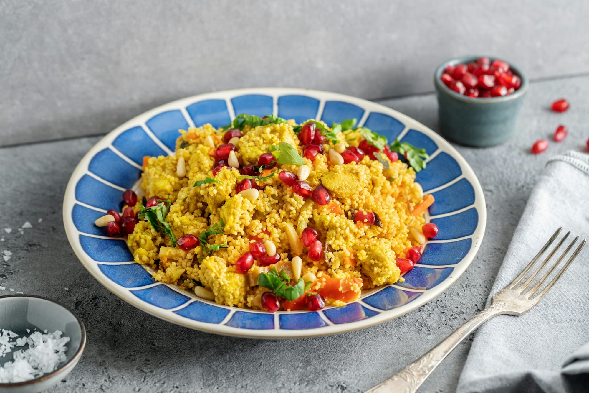 Cous cous served on plate on grey background