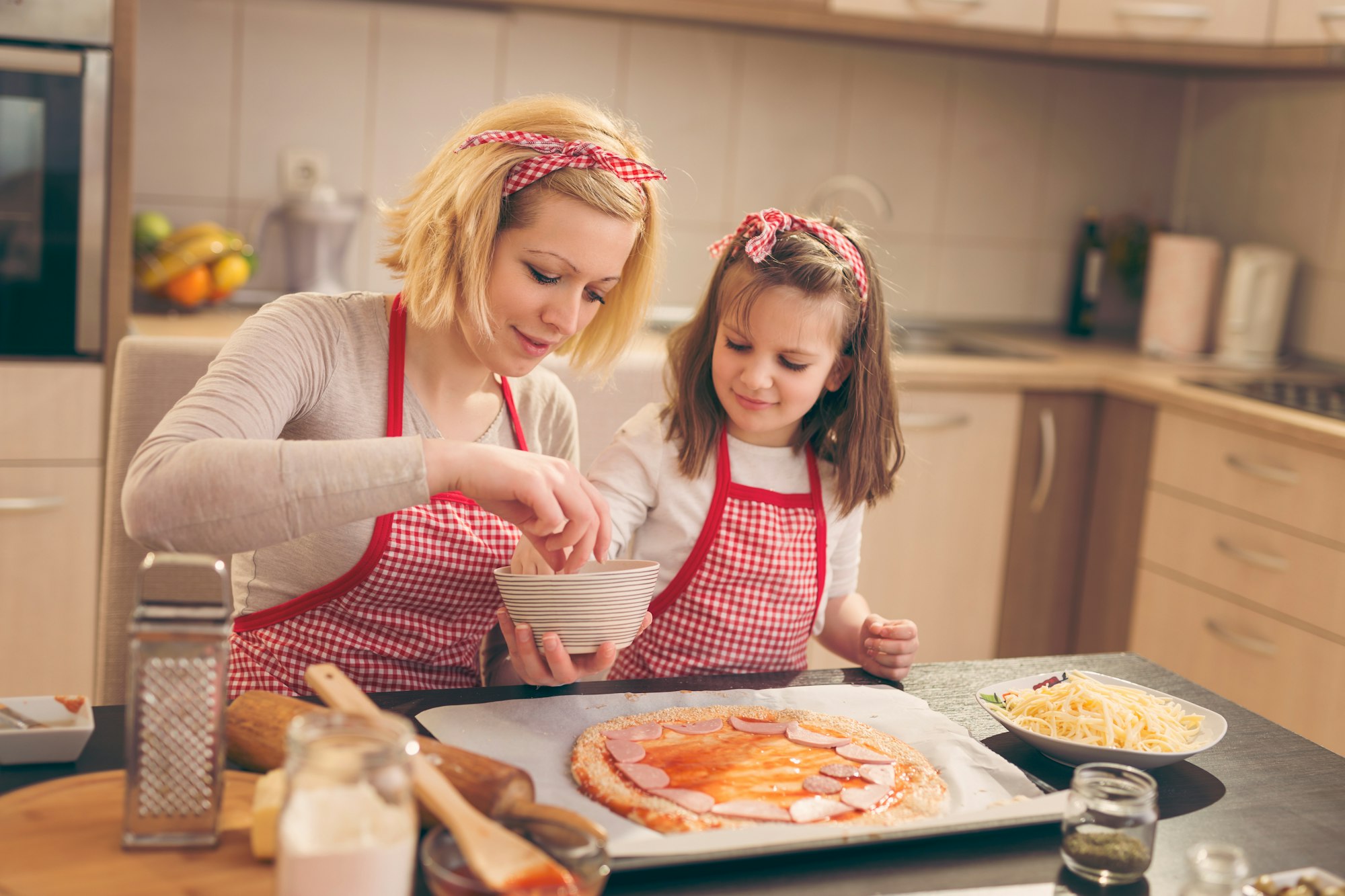 Putting salami on the pizza dough