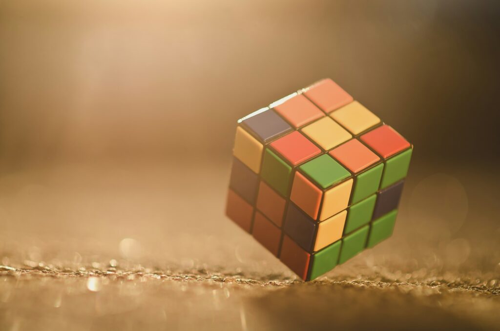 Rubik's cube located on the colored background,