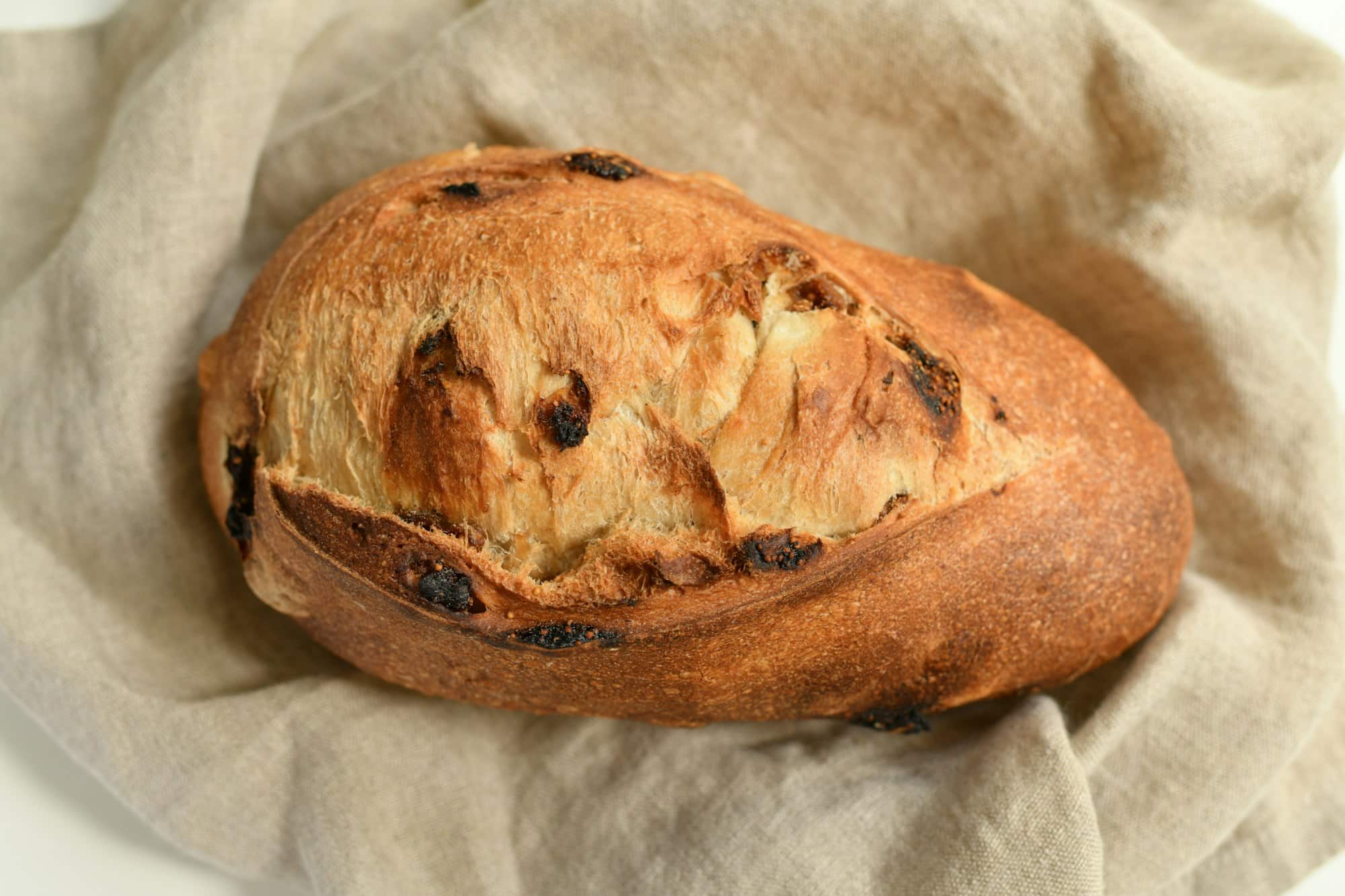 Delicious bread with figs on a natural beige background