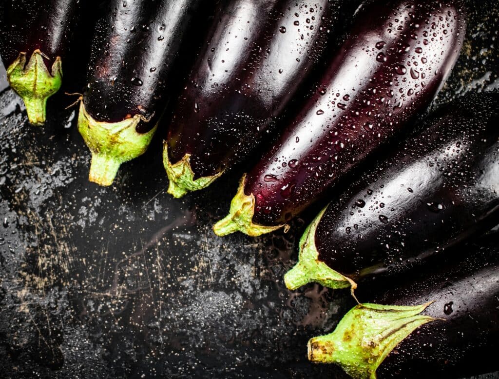 Ripe eggplant with droplets of water.